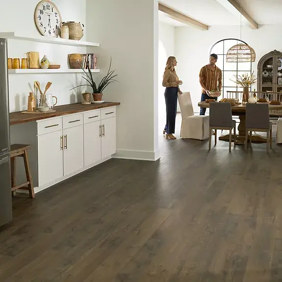 Open kitchen and dining room featuring dark wood-look flooring.