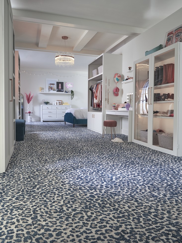Blue leopard-print carpet in a modern walk-in dressing room.