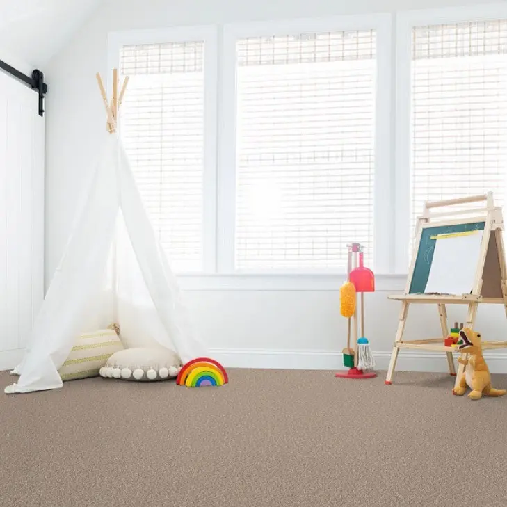 Warm tan carpet in a child's playroom with a white teepee tent and easel.